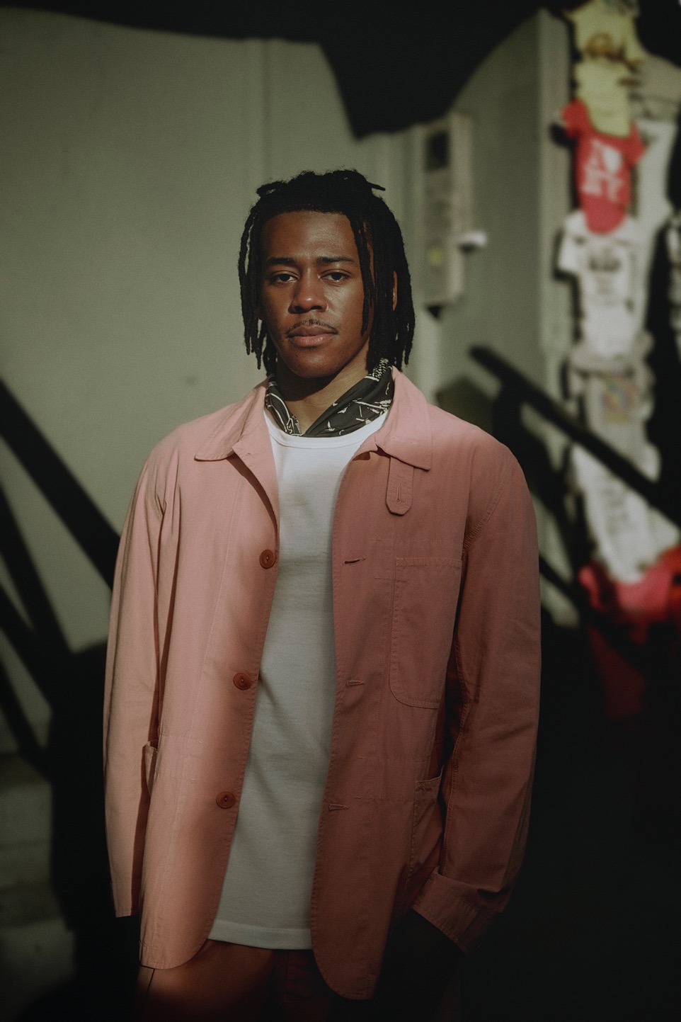man wearing white t-shirt, jacket and bandana